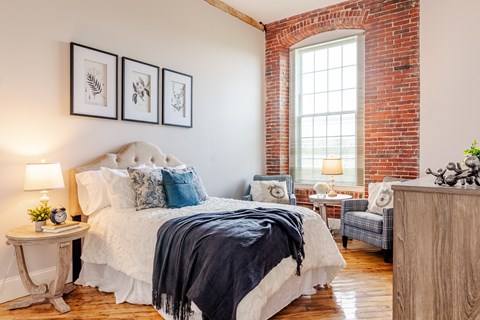 a bedroom with a bed and a chair